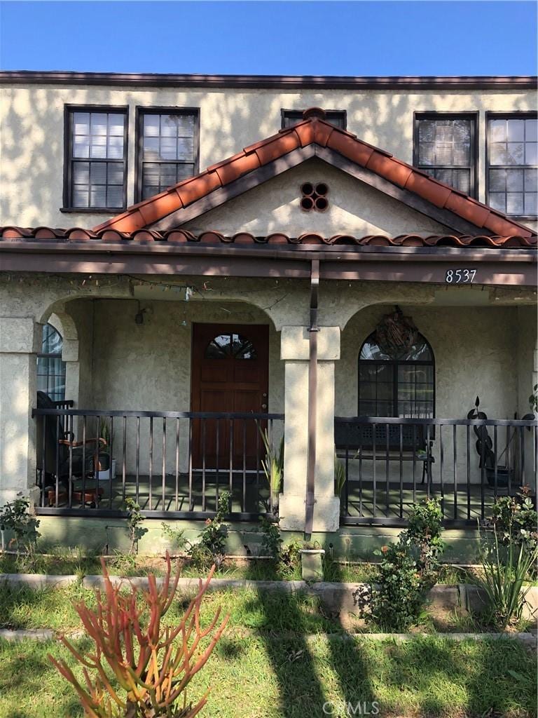view of front of home with a porch and stucco siding