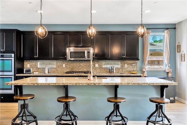 26165 Santiago Canyon Rd, Corona, CA 92883 - kitchen featuring a sink, appliances with stainless steel finishes, decorative backsplash, and a kitchen bar