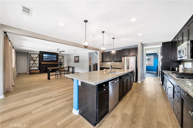 26165 Santiago Canyon Rd, Corona, CA 92883 - kitchen with a sink, stainless steel appliances, visible vents, and light wood-style floors