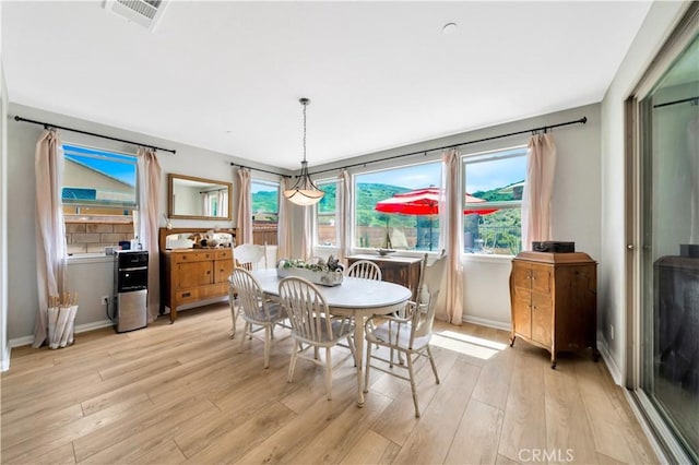 26165 Santiago Canyon Rd, Corona, CA 92883 - dining space with a wealth of natural light, visible vents, light wood-style flooring, and baseboards