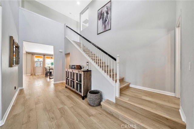 26165 Santiago Canyon Rd, Corona, CA 92883 - stairs featuring baseboards, a towering ceiling, and wood finished floors