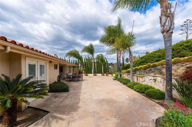 view of patio with french doors and outdoor dining space
