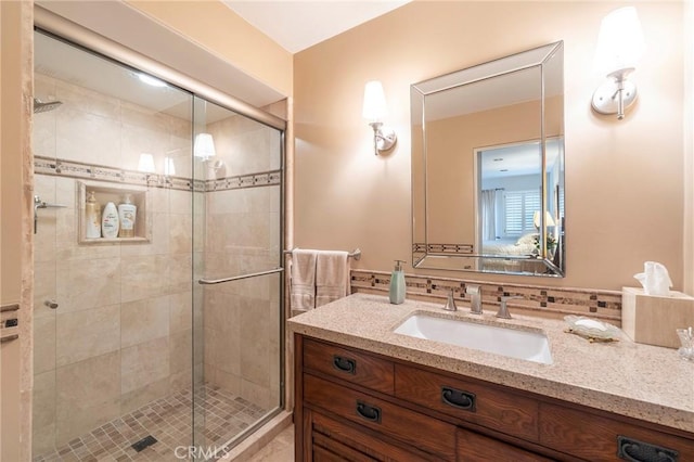 full bathroom with vanity and a stall shower