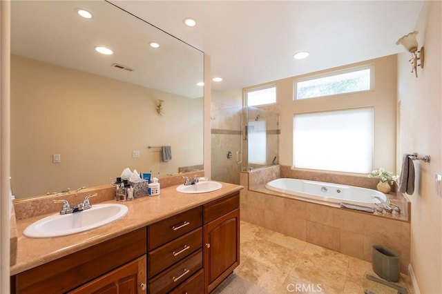full bath featuring tiled shower, a sink, a garden tub, and visible vents