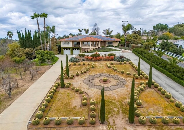 view of property's community featuring concrete driveway and a garage