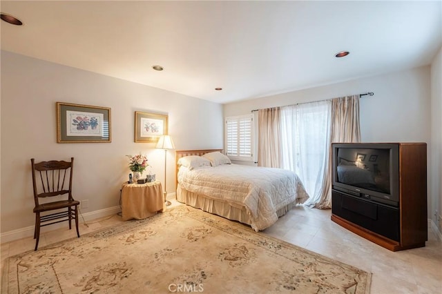 tiled bedroom featuring baseboards