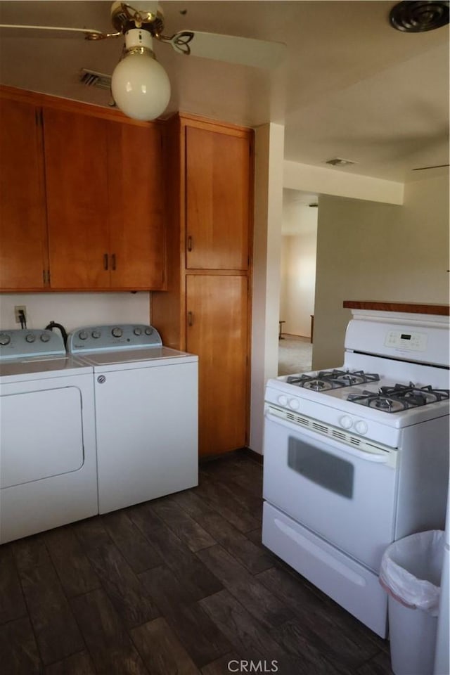 kitchen featuring dark wood-style floors, separate washer and dryer, brown cabinets, light countertops, and white gas range