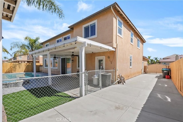 29851 Fox Creek Dr, Menifee, CA 92586 - back of property featuring a gate, stucco siding, a fenced backyard, ceiling fan, and a patio area