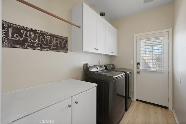 29851 Fox Creek Dr, Menifee, CA 92586 - laundry area with independent washer and dryer, cabinet space, light wood-type flooring, and baseboards
