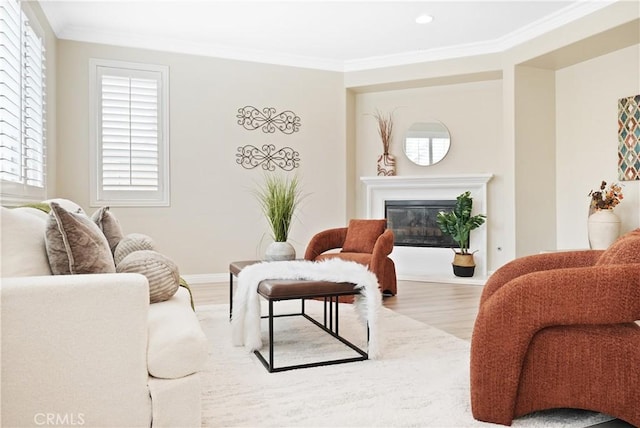 29851 Fox Creek Dr, Menifee, CA 92586 - living area with wood finished floors, ornamental molding, a glass covered fireplace, recessed lighting, and baseboards
