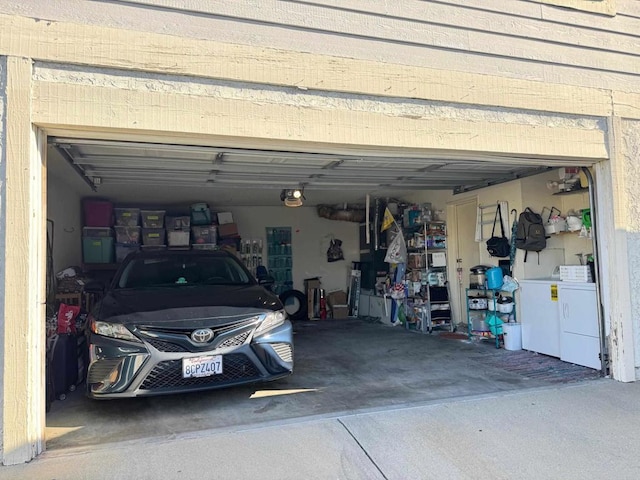 garage with washer and dryer and a garage door opener