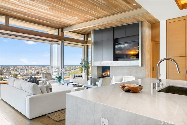 1231 Dolphin, Corona Del Mar, CA 92625 - living area with light tile patterned floors, floor to ceiling windows, a fireplace, and wooden ceiling