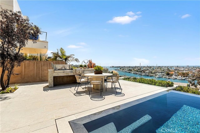 1231 Dolphin, Corona Del Mar, CA 92625 - view of swimming pool featuring fence, a water view, exterior kitchen, outdoor dining area, and a patio area