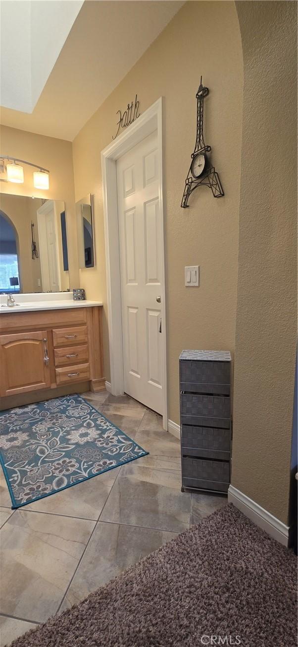 bathroom with baseboards and vanity