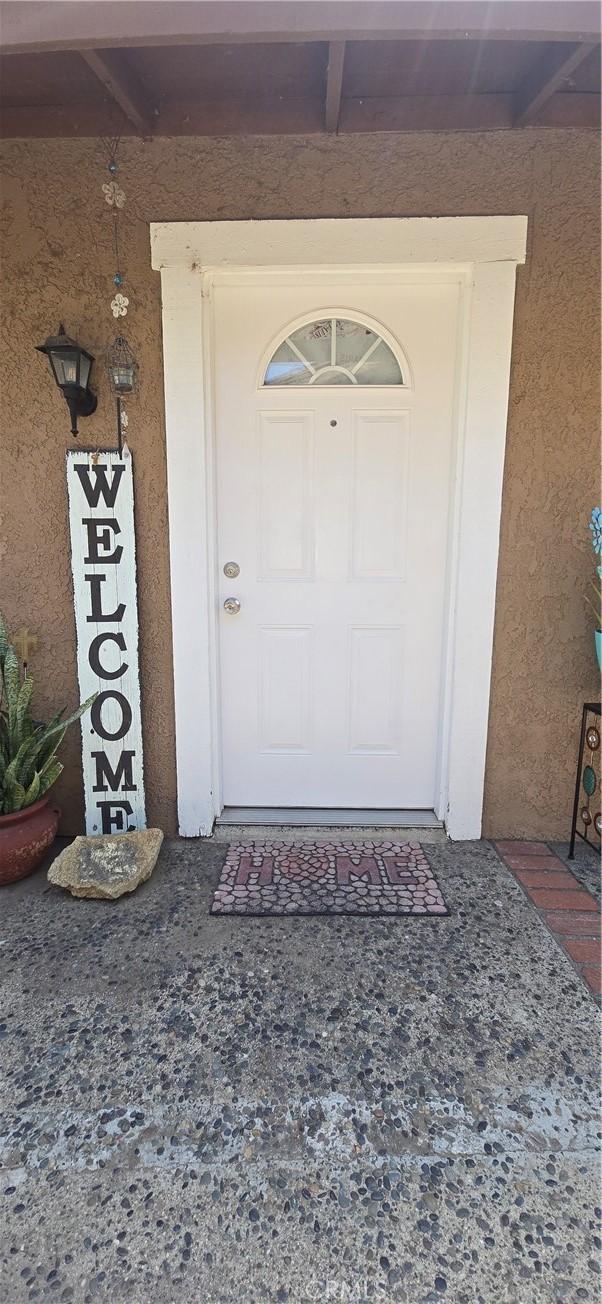 property entrance with stucco siding