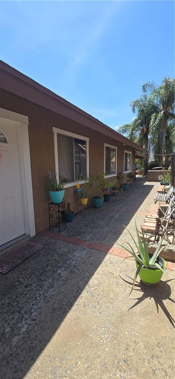 exterior space with stucco siding and a patio area