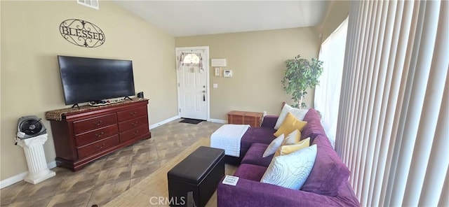 living area featuring baseboards and visible vents
