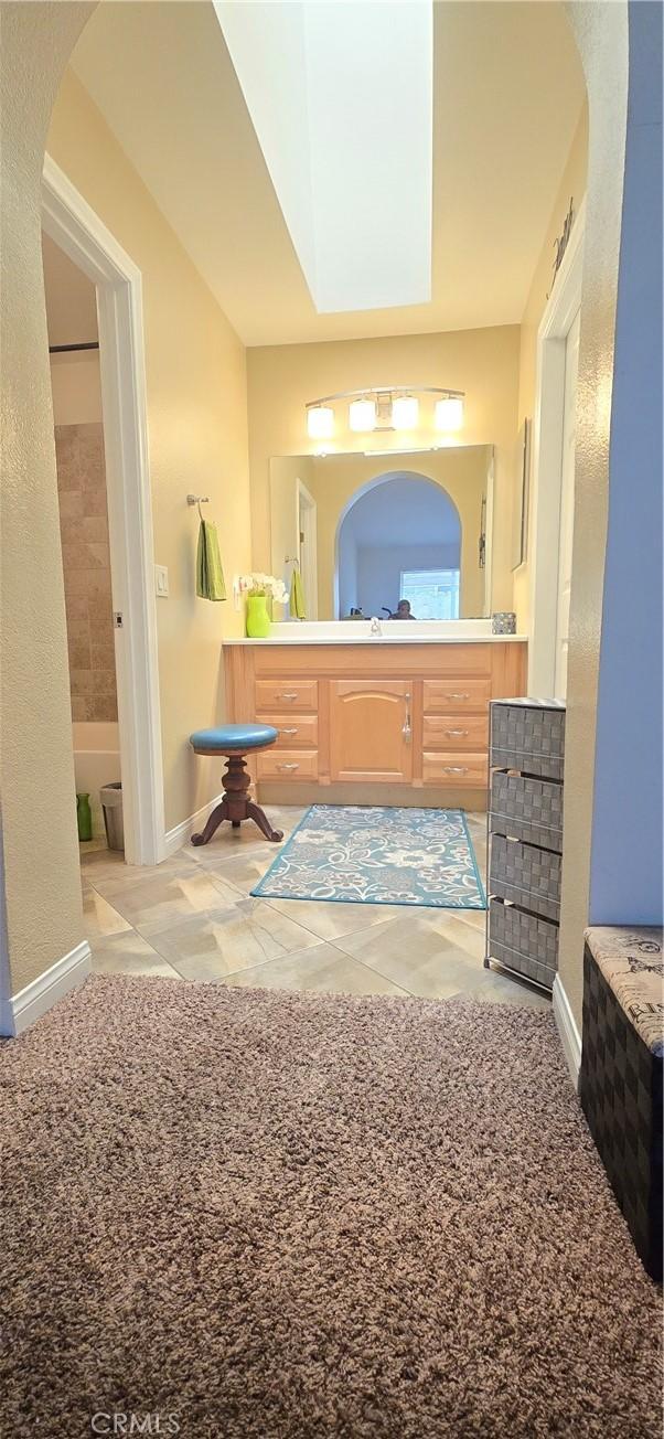 bathroom featuring vanity, tile patterned flooring, and baseboards