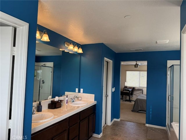 1445 Sandy Hill Dr, Calimesa, CA 92320 - full bathroom featuring baseboards, a sink, a shower stall, and connected bathroom