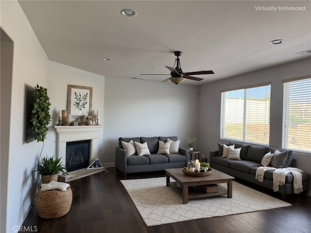 1445 Sandy Hill Dr, Calimesa, CA 92320 - living area with hardwood / wood-style flooring, a glass covered fireplace, ceiling fan, baseboards, and visible vents
