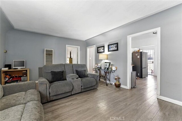2965 Poplar Dr, Lynwood, CA 90262 - living room featuring wood finished floors and baseboards