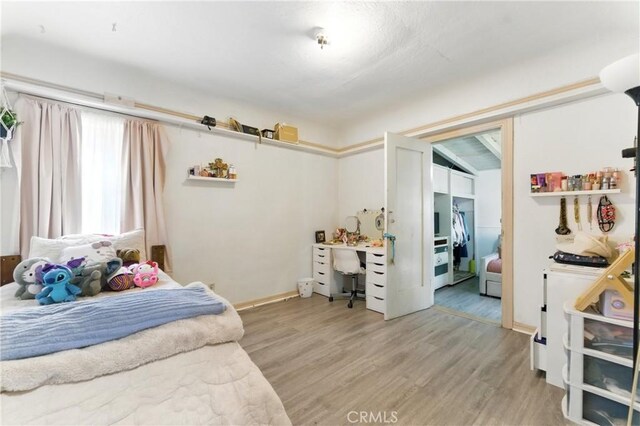 2965 Poplar Dr, Lynwood, CA 90262 - bedroom with light wood finished floors and a desk