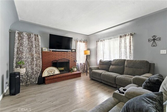 2965 Poplar Dr, Lynwood, CA 90262 - living room with wood finished floors and a fireplace