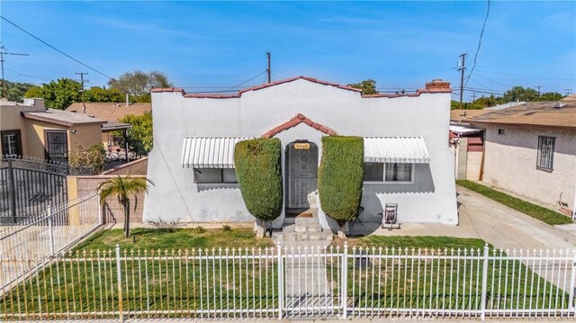 2965 Poplar Dr, Lynwood, CA 90262 - mediterranean / spanish home featuring stucco siding and a fenced front yard