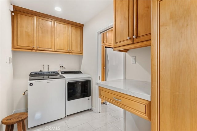 15936 Osborne St, North Hills, CA 91343 - laundry room featuring independent washer and dryer, cabinet space, baseboards, and light tile patterned flooring