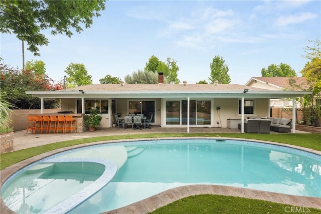 back of property with outdoor dry bar, an outdoor hangout area, stucco siding, and a patio area