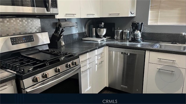 1725 Truman Cir, Placentia, CA 92870 - kitchen featuring stainless steel appliances, a sink, white cabinetry, and backsplash