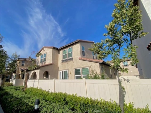 5772 Marabe Way, Riverside, CA 92505 - rear view of property with fence, stucco siding, and a tile roof