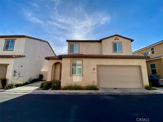 5772 Marabe Way, Riverside, CA 92505 - mediterranean / spanish house featuring an attached garage, a tile roof, and stucco siding