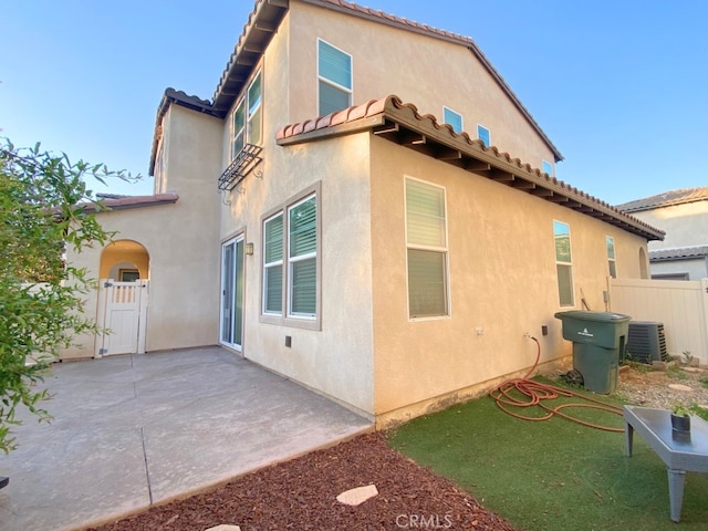 5772 Marabe Way, Riverside, CA 92505 - view of home's exterior featuring fence, central AC unit, stucco siding, and a patio area