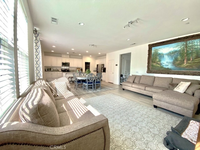 5772 Marabe Way, Riverside, CA 92505 - living area with visible vents, recessed lighting, light wood-style flooring, and a wealth of natural light