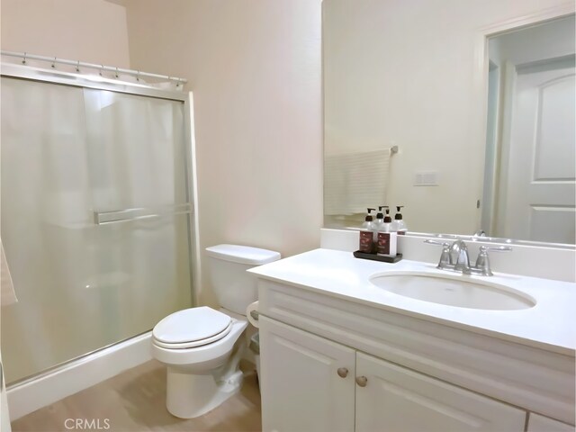 5772 Marabe Way, Riverside, CA 92505 - bathroom with vanity, a shower stall, and toilet