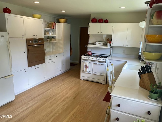 kitchen with open shelves, light countertops, and white appliances