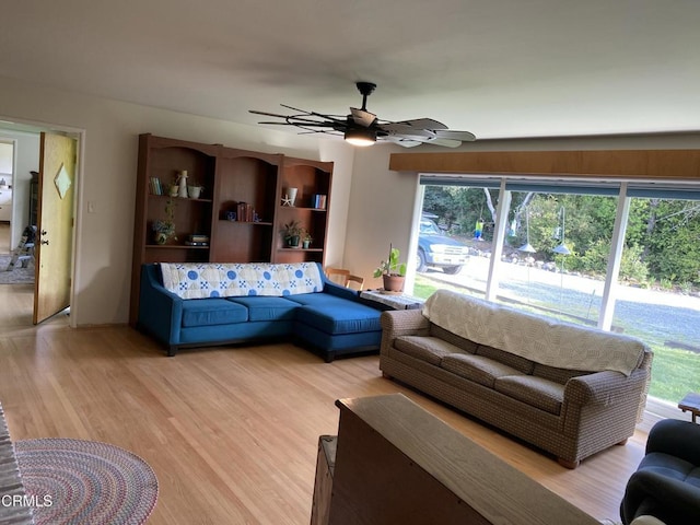 living area with ceiling fan and light wood-style floors