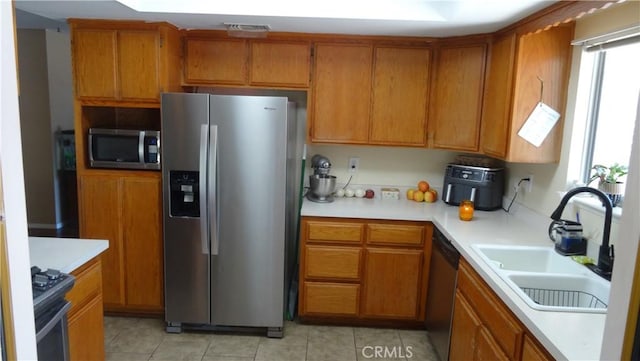 6301 Park Ave, Lake Isabella, CA 93240 - kitchen featuring brown cabinets, light countertops, a sink, and stainless steel appliances