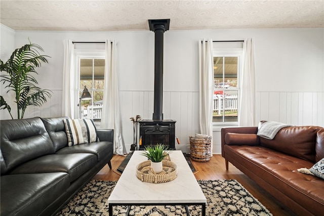 2007 3rd St, Julian, CA 92036 - living room with a wood stove, wainscoting, an ornate ceiling, and wood finished floors