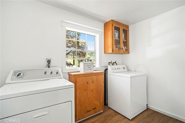 2007 3rd St, Julian, CA 92036 - clothes washing area with light wood-type flooring, washer and clothes dryer, and cabinet space