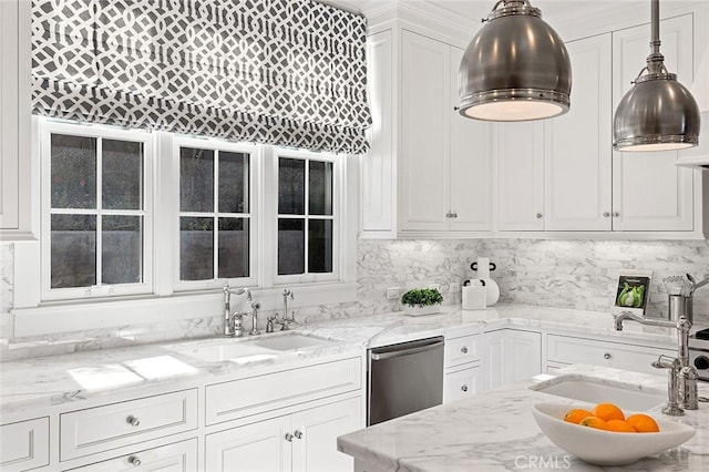 kitchen featuring dishwasher, white cabinets, a sink, and pendant lighting