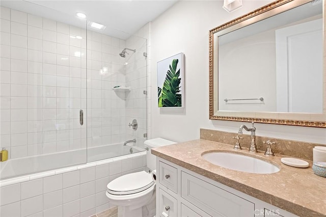 bathroom with toilet, tiled shower / bath combo, recessed lighting, and vanity