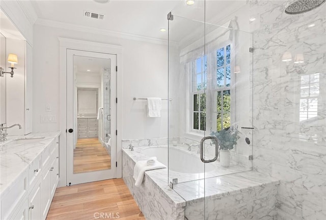 bathroom featuring a marble finish shower, crown molding, and wood finished floors