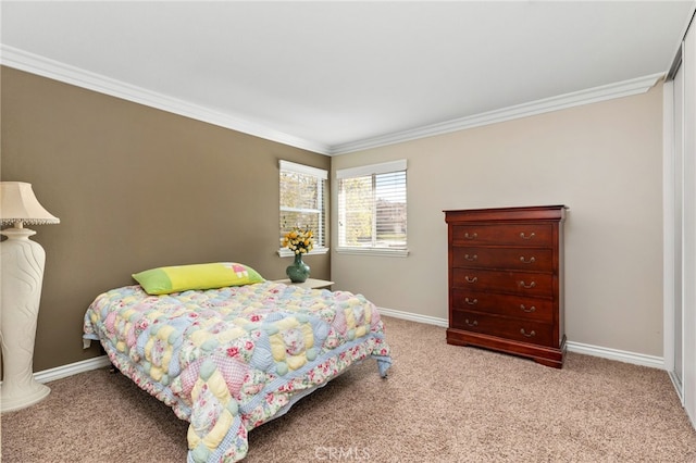 bedroom featuring crown molding, baseboards, and light colored carpet