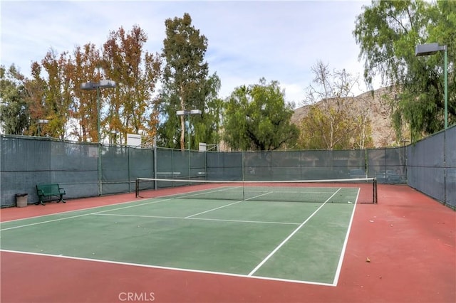 view of sport court featuring fence