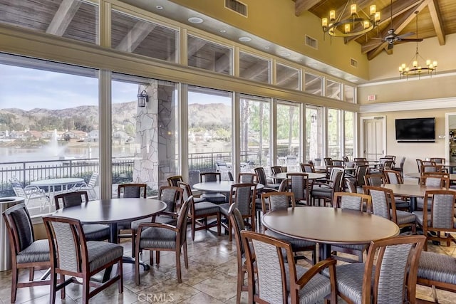 dining space with visible vents, beam ceiling, and wood ceiling