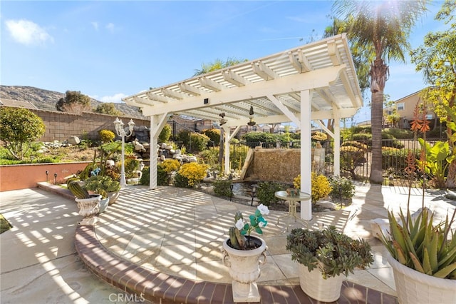 view of patio / terrace featuring a fenced backyard and a pergola