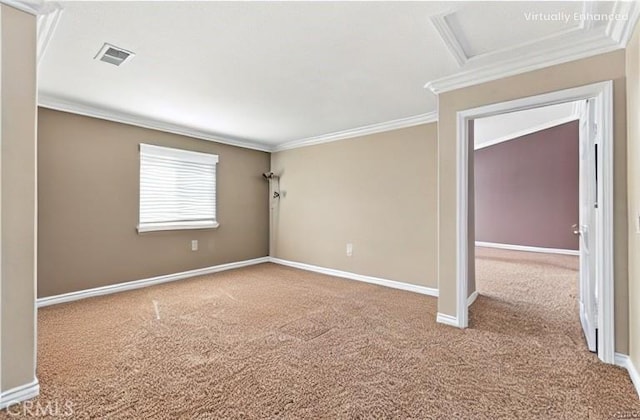 carpeted spare room featuring attic access, baseboards, and crown molding