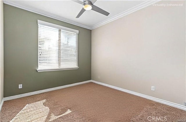 carpeted spare room featuring baseboards, ornamental molding, and a ceiling fan